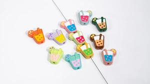 Macro detail of colorful hand-painted juice cup beads with pre-drilled holes for DIY