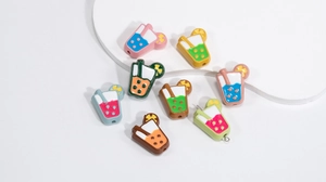Macro detail of colorful enamel cup beads with straws for DIY jewelry making