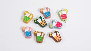 Macro shot of colorful resin beverage charms with straw and lemon slice for DIY crafts