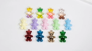 Macro shot of colorful acrylic bear charms in transparent, pastel, and metallic finishes