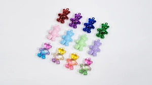Flat lay of colorful acrylic bear charms in metallic, macaron, and gradient resin styles