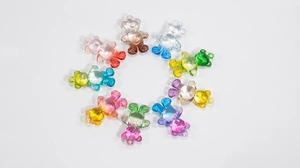 Macro shot of colorful transparent acrylic bear charms for DIY jewelry and keychain crafts