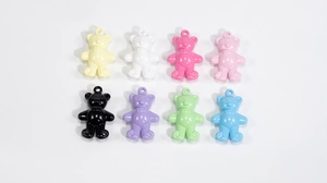 Close-up of colorful acrylic mini bears showing smooth texture and top hanging loops