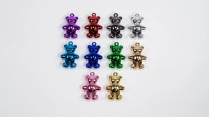 Macro shot of colorful acrylic bear charms with metallic finish for DIY jewelry crafts
