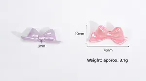 Macro shot of 45mm pearlescent acrylic bow beads with size markings for DIY jewelry making