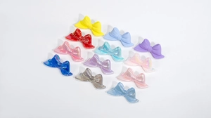 Macro shot of colorful acrylic bow beads with pearlescent finish for DIY crafts