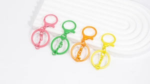 Detail of colorful matte lobster clasps in pink, green, orange, and yellow hues