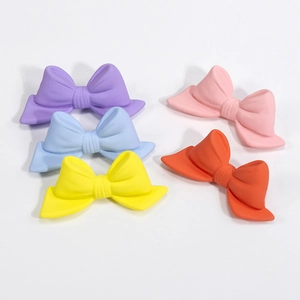 Colorful matte acrylic bow beads in purple, blue, yellow, pink, and orange for DIY jewelry