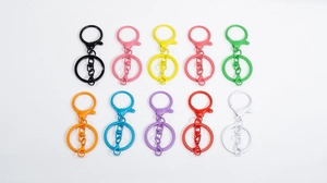 Close-up of colorful paint lobster clasps and key rings in ten vibrant assorted colors