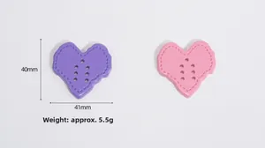 Detail of 40x41mm heart-shaped acrylic buttons with five holes in purple and pink