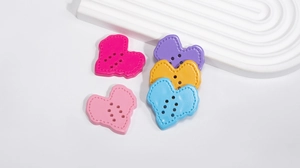 Flat lay of colorful heart-shaped acrylic buttons for DIY crafts and jewelry making