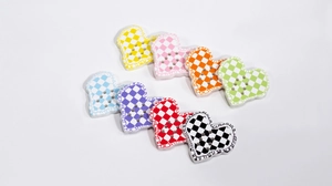Macro shot of colorful checkered heart buttons for DIY jewelry and phone charms