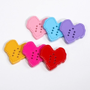 Colorful heart-shaped acrylic buttons with six holes and stitching detail for DIY crafts