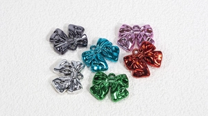 Close-up of metallic bow charms in six vibrant colors for DIY jewelry and accessory making