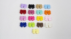 Detailed collection of colorful acrylic bow charms with top holes for DIY jewelry making