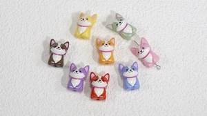 Macro detail of colorful acrylic corgi dog beads for DIY jewelry and phone chain making