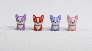 Set of four colorful acrylic puppy beads in purple, orange, light blue and pink for DIY crafts
