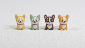 Close-up of colorful acrylic puppy charms with textured collars and glittery details