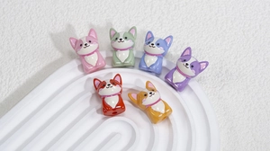 Macro shot of colorful 3D acrylic corgi puppy beads for DIY jewelry making and crafts