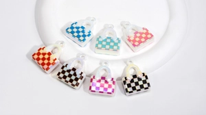 Detailed view of colorful acrylic checkered bag charms with a pearlescent finish