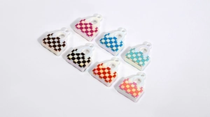 Close-up of colorful acrylic checkerboard bag charms with glossy finish for DIY crafts