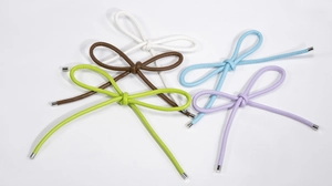 Detail of five PU leather woven bow pendants in white brown blue purple and lime green