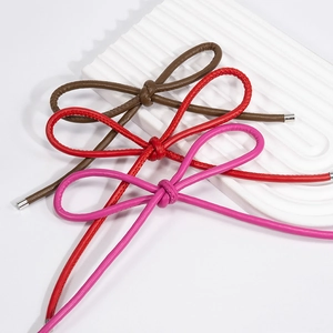 Braided leather bow keychains in brown, red and pink with silver metal ends