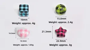 Macro shot of colorful acrylic plaid beads in heart and star shapes for DIY jewelry making