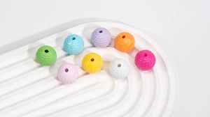 Detailed macro view of colorful acrylic woven round beads for DIY jewelry and crafts