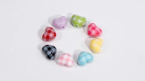 Macro shot of colorful heart-shaped acrylic plaid beads for DIY jewelry making