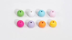 Macro view of eight colorful acrylic woven beads for DIY jewelry and keychain making