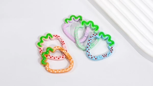 Detail of colorful strawberry-shaped alloy spring clips with cute polka dot patterns