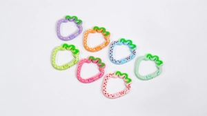 Macro view of colorful strawberry shaped alloy spring ring clasps with polka dot details