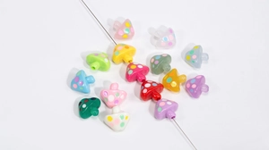 Close-up of colorful acrylic mushroom beads with polka dots for DIY jewelry making