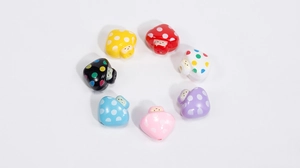 Detailed view of colorful acrylic mushroom beads with smile faces and polka dots