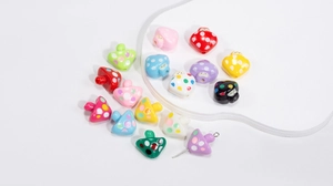 Macro detail of colorful acrylic mushroom beads with polka dots for DIY jewelry making