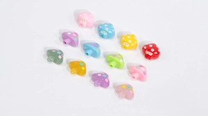 Macro view of colorful acrylic mushroom beads with cute smiley faces for DIY jewelry making