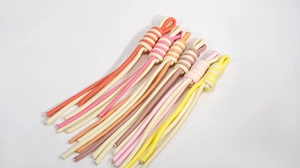 Macro view of six colorful spiral braided wrist straps with durable ring connectors