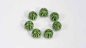 Detailed macro view of acrylic watermelon beads with green stripes for DIY jewelry making