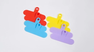 Flat lay of colorful flexible silicone phone lanyard tabs in red, blue, and yellow