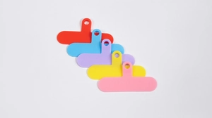 Close-up of colorful universal phone lanyard tether pads in red, blue, and purple tones