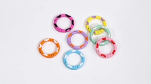 Detailed view of colorful speckled metal spring gate rings for DIY accessories