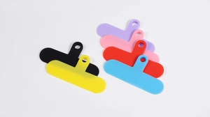Close-up of colorful T-shaped phone lanyard connector tabs in various silicone finishes