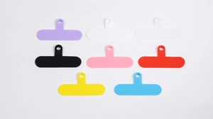 Close-up of T-shaped phone lanyard connector tabs in eight vibrant various colors