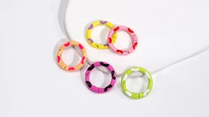 Detailed view of five colorful polka dot spring gate rings for DIY keychains