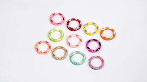 Detailed set of eleven colorful spray-painted spring rings for DIY jewelry making