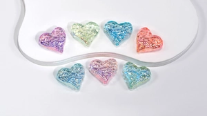 Macro detail of heart-shaped iridescent beads with ice-cracked texture and AB coating