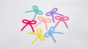 Detailed view of colorful acrylic bow beads for DIY necklaces and handmade jewelry accessories