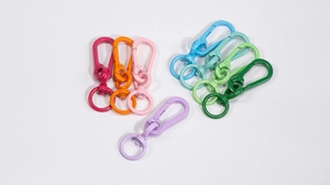 Close-up of colorful spring snap hooks in eight vibrant shades for DIY bag accessories