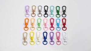 Detailed grid of twenty-one colorful metal lobster clasps for DIY keychains and bags